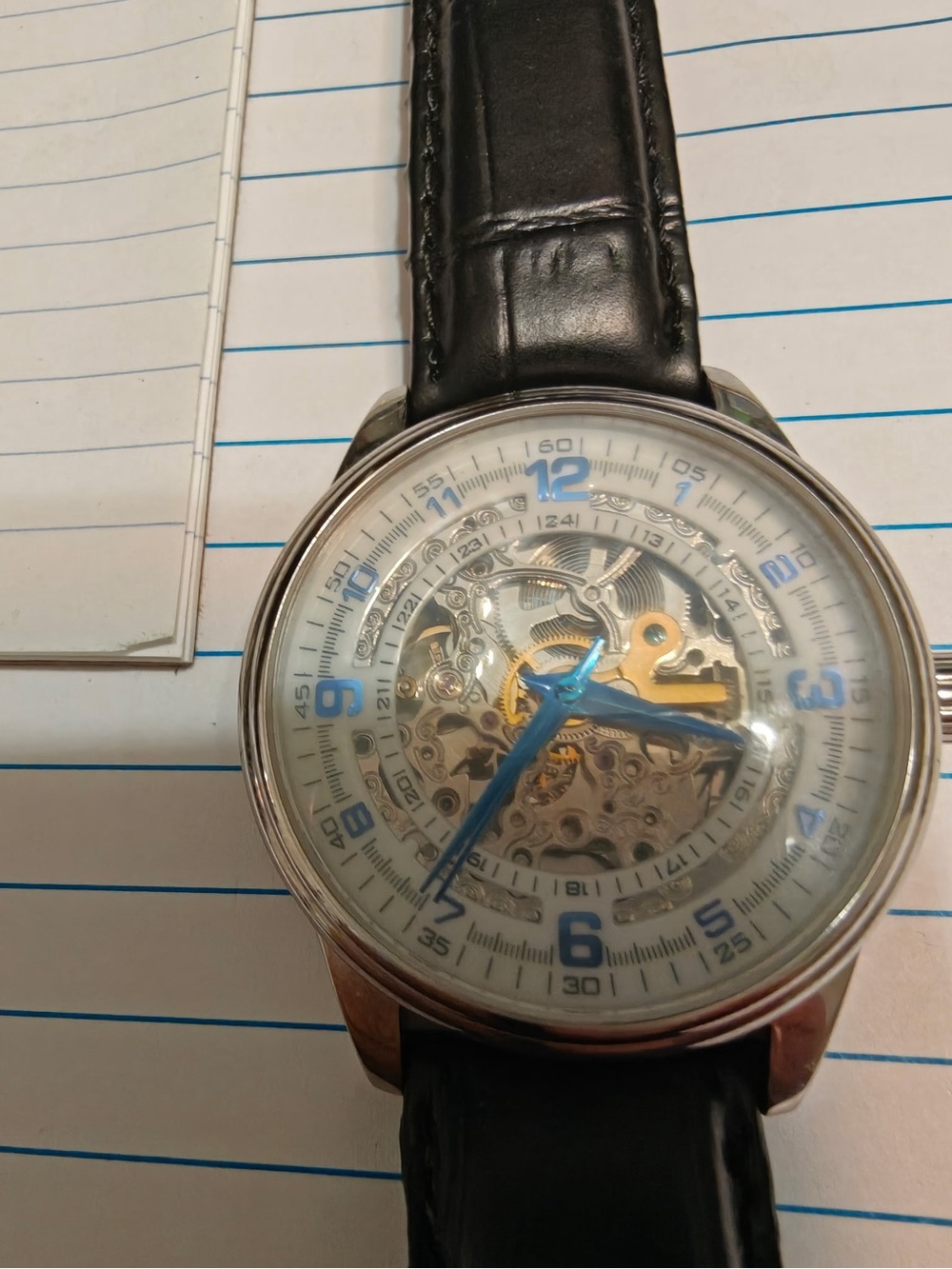 Akribos XXIV Black Leather Strap Skeleton Dial Watch with Blue Hands